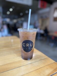 Coffee inside CRU Café Newport RI with latte art and cozy interior