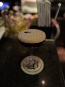 Espresso martini at the bar at 22 Bowen’s with a classic coupe glass and lively evening atmosphere.