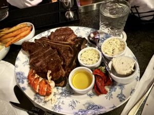 Ribeye tomahawk plate at 22 Bowen’s featuring a thick, bone in steak with classic grille presentation.