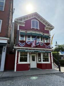 Front view of Benjamin’s Restaurant and Raw Bar on Thames Street in Newport Rhode Island with coastal architecture.