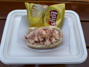 Close up of a lobster roll from The Lobster Shack in Newport Rhode Island served on a toasted bun with fresh lobster meat.