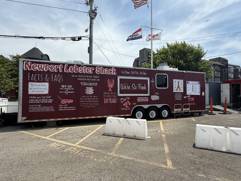 Front view of The Lobster Shack in Newport Rhode Island located on Clarke Street with seating near the harbor.
