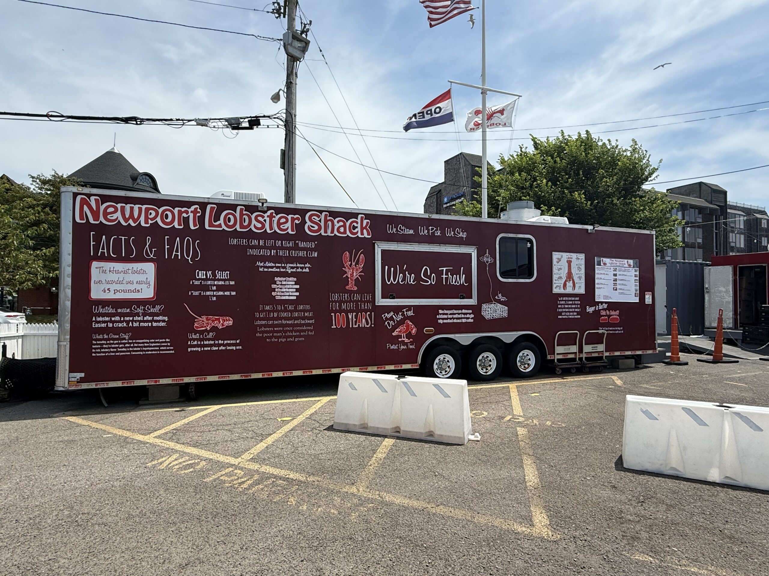 Front view of The Lobster Shack in Newport Rhode Island located on Clarke Street with seating near the harbor.