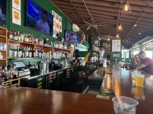 Interior bar view at O’Brien’s Pub in Newport Rhode Island with guests, bar seating, and drink selections.