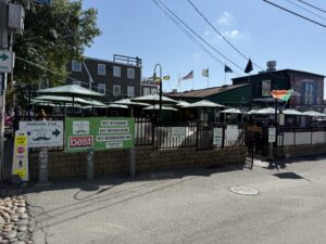 Outdoor patio at O’Brien’s Pub in Newport Rhode Island with guests enjoying food and drinks.