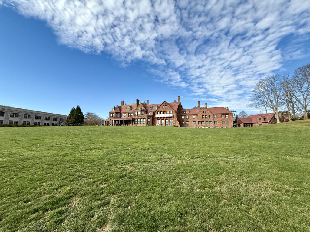 View of Salve Regina University in Newport RI with historic buildings and oceanfront cliffs.
