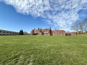 View of Salve Regina University in Newport RI with historic buildings and oceanfront cliffs.